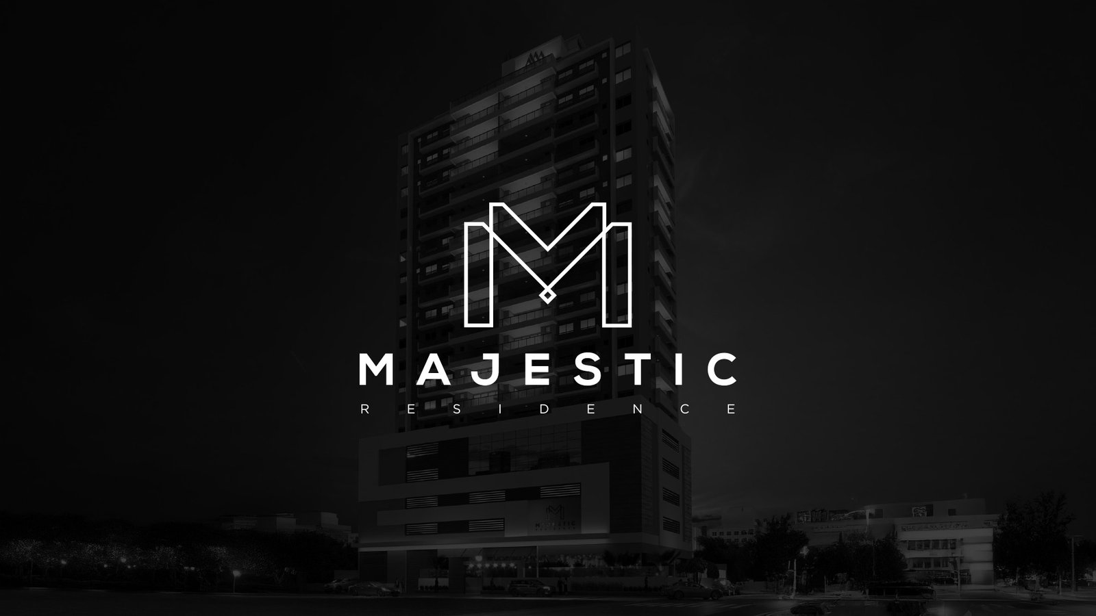 Marca do residencial Majestic aplicada sobre fachada noturna